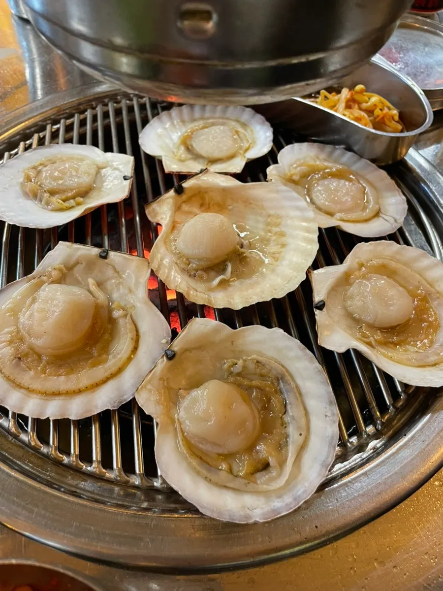 Scallops cooking over the charcoal burner