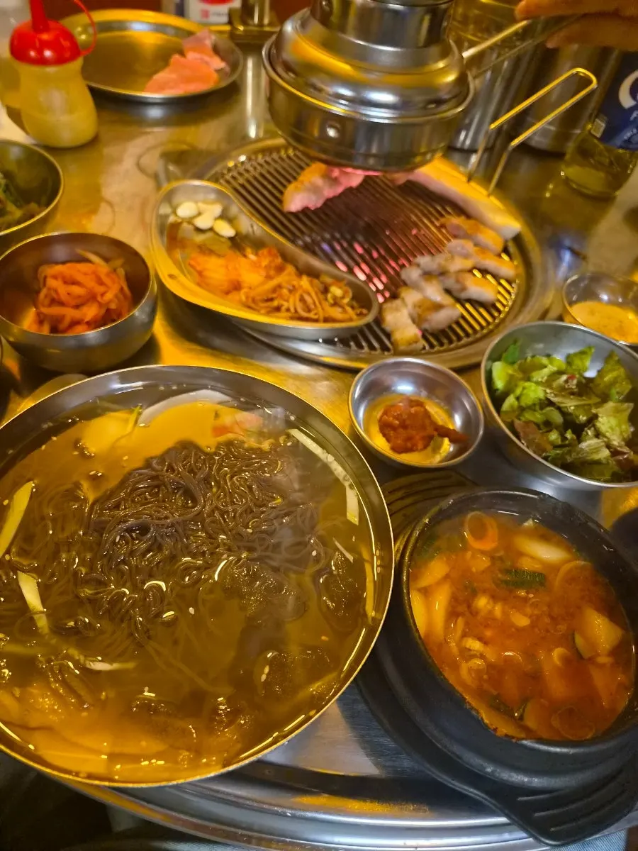 Table spread with doenjang stew and cold noodles together