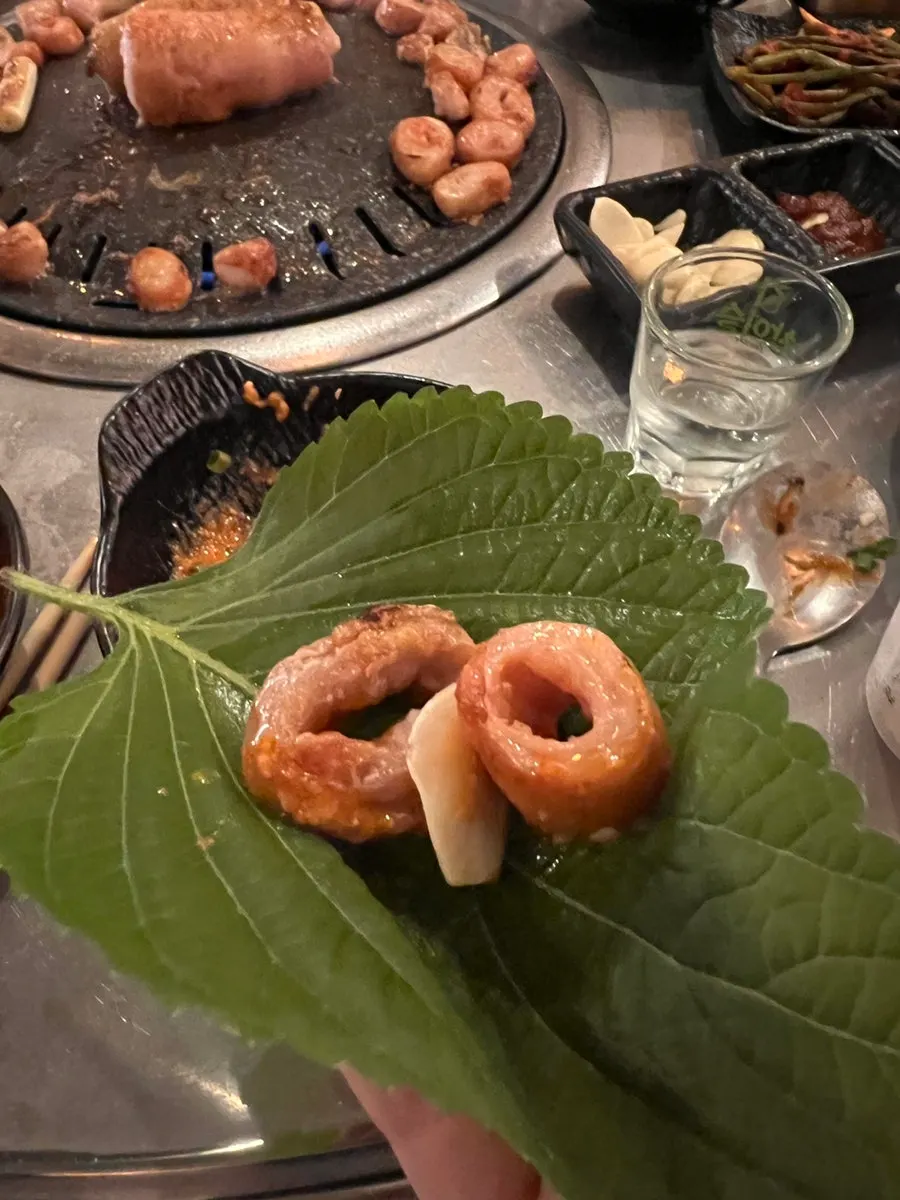 Daegu makchang wrapped in a perilla leaf