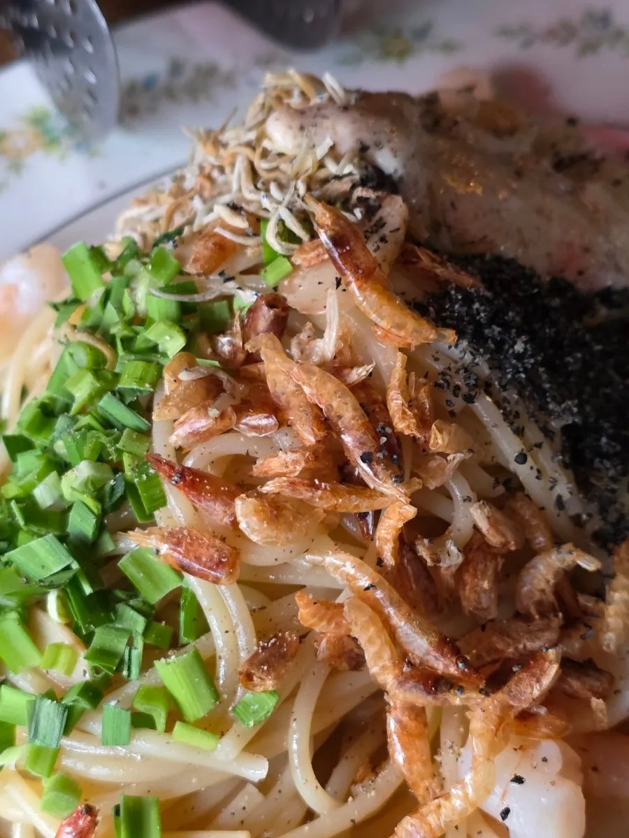 Close-up of the oil pasta topped with dried shrimp
