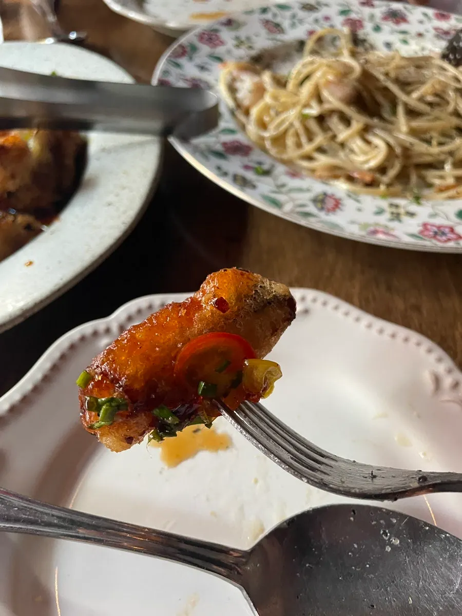 A bite of eggplant picked up with chopsticks