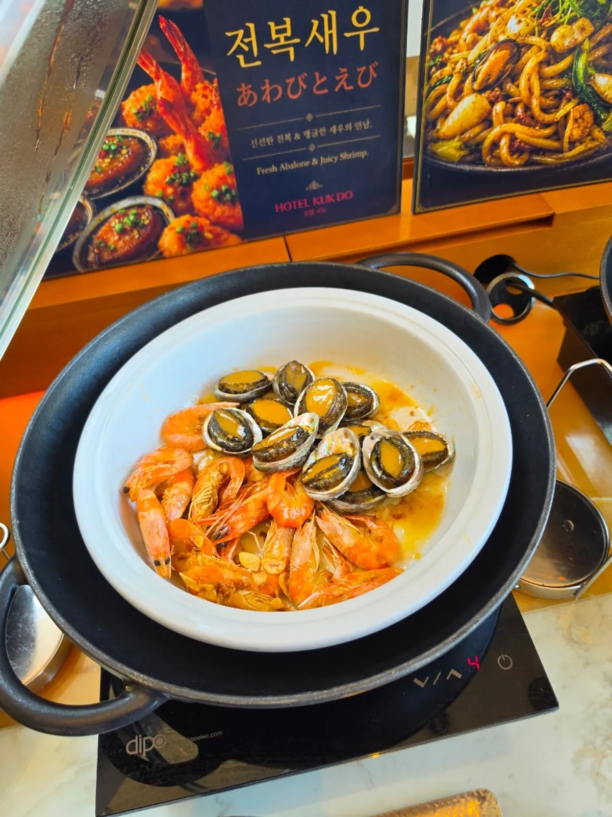 Tray of abalone and shrimp dishes on the buffet