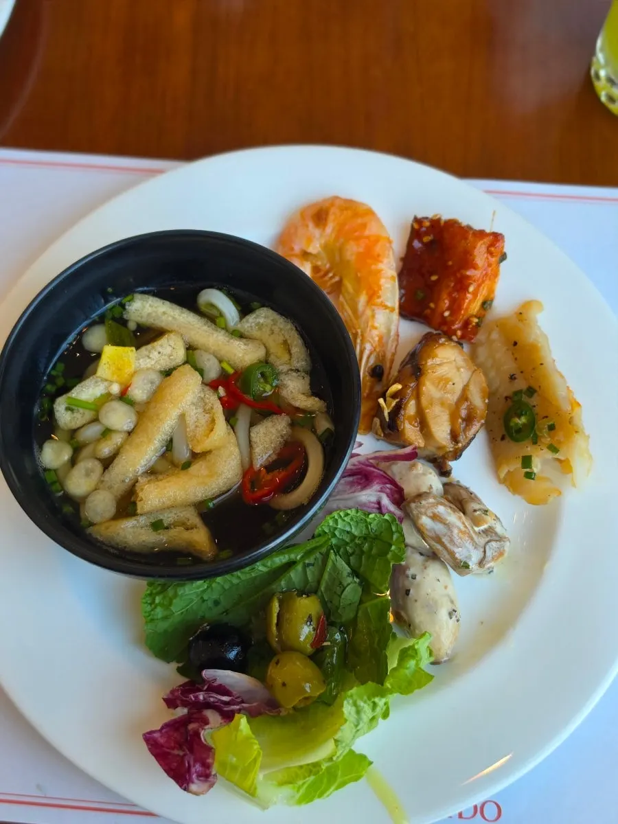 A plate loaded with various buffet dishes