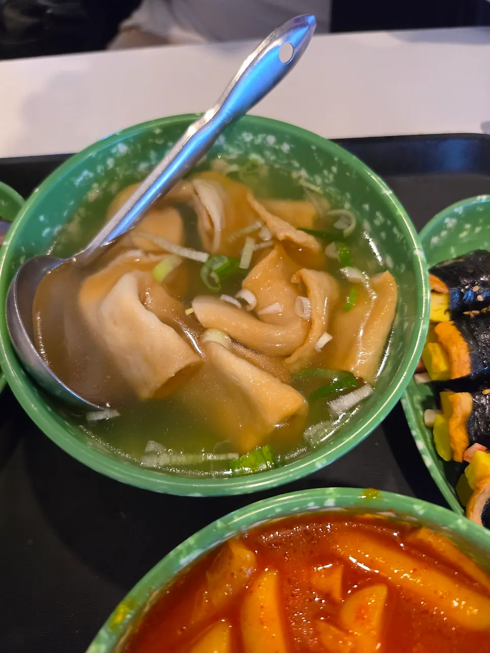 Warm fish-cake broth topped with green onion