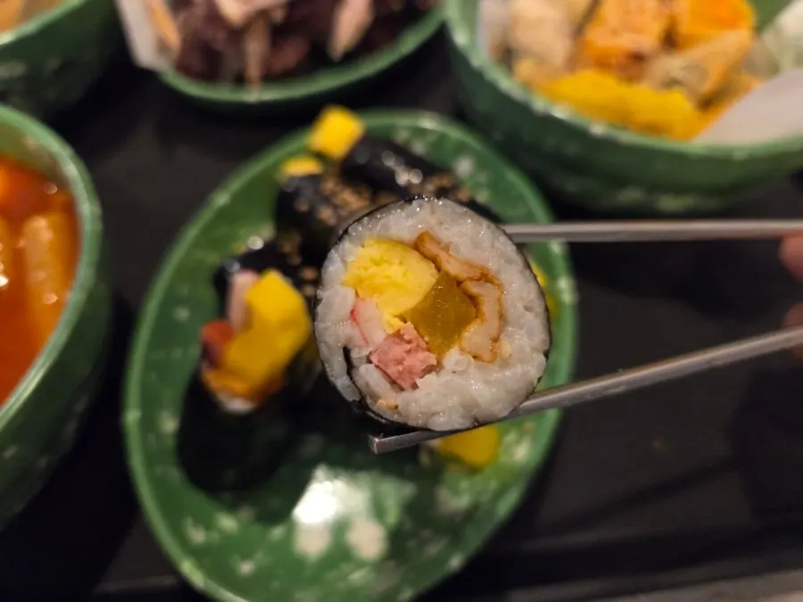 Four pieces of mini gimbap filled with pickled radish and ham