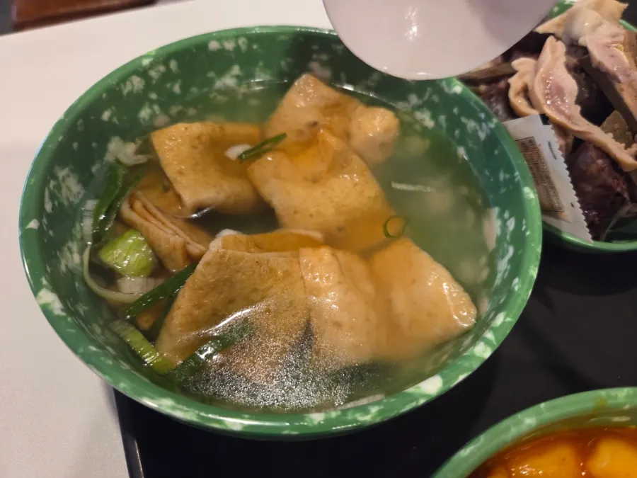 Mini gimbap dipped in tteokbokki broth