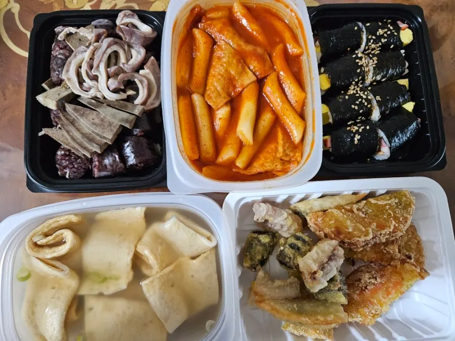 Combo set with sundae, tteokbokki, mini gimbap, mixed fritters, and fish cake