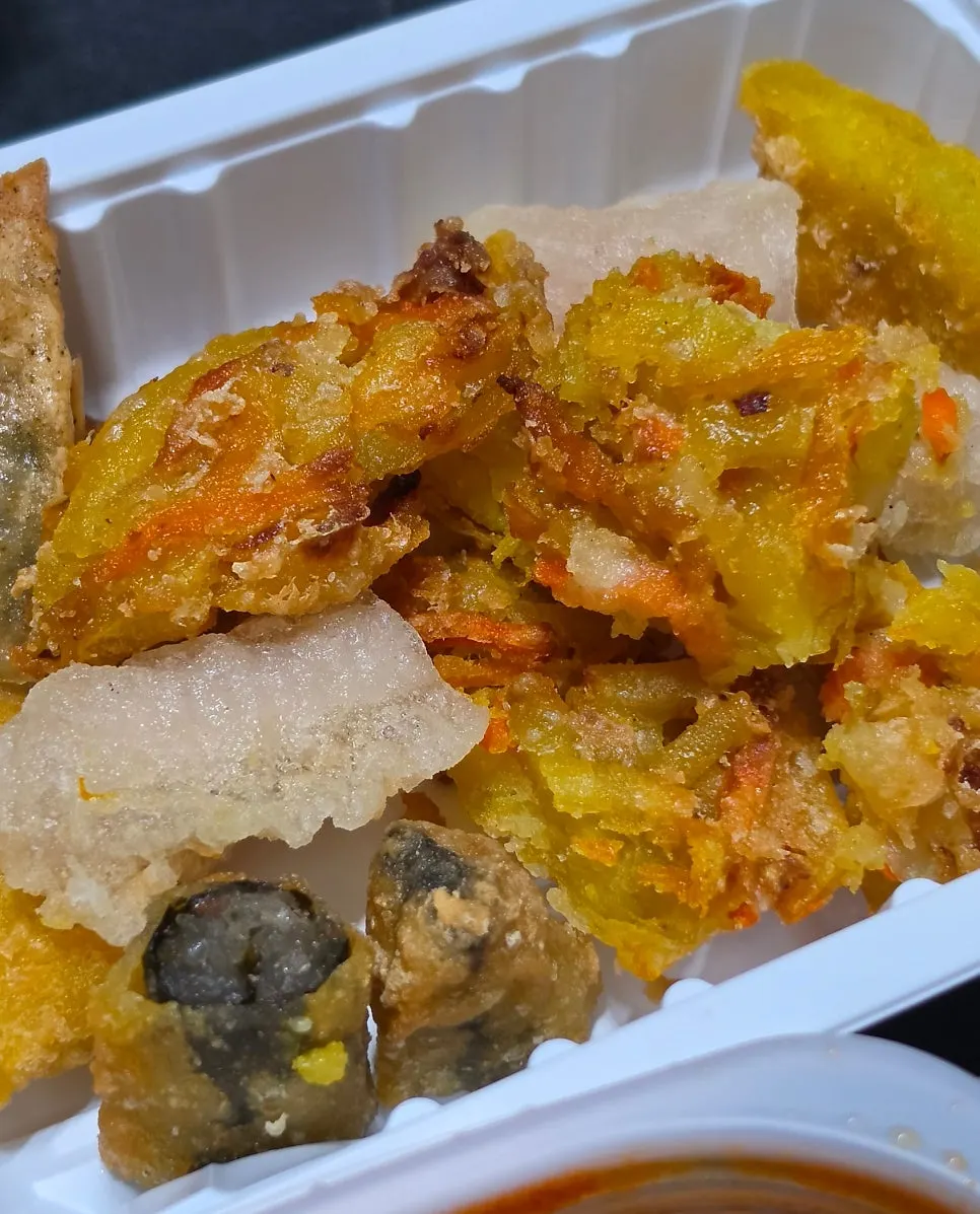 Assorted fried snacks including glass noodle rolls and squid