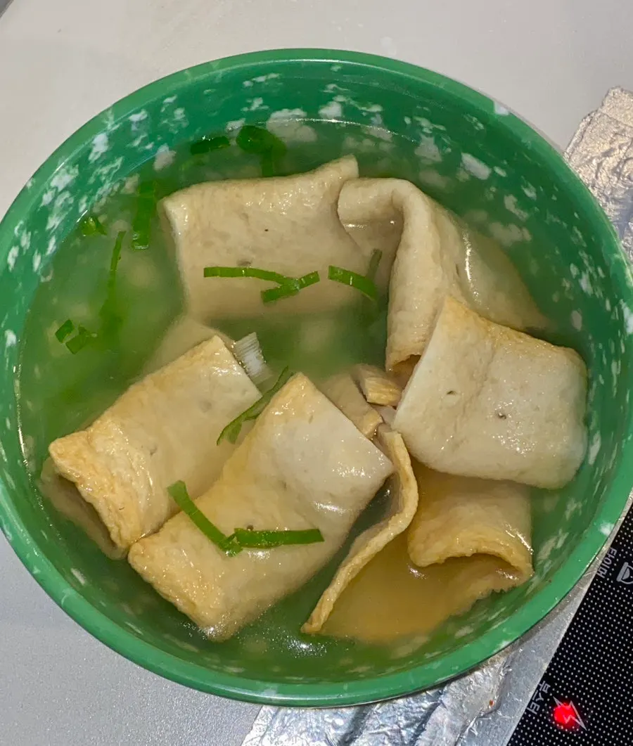 A bowl of fish cake served with the skewers removed