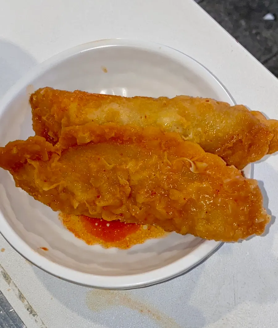 Fried mandu fished out onto a small plate