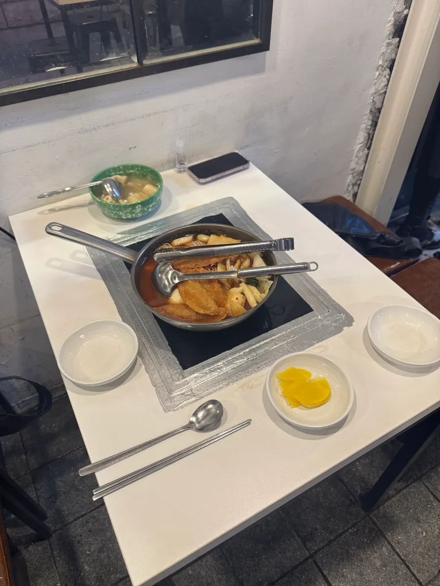 A full pot of instant tteokbokki for two, freshly set on the table