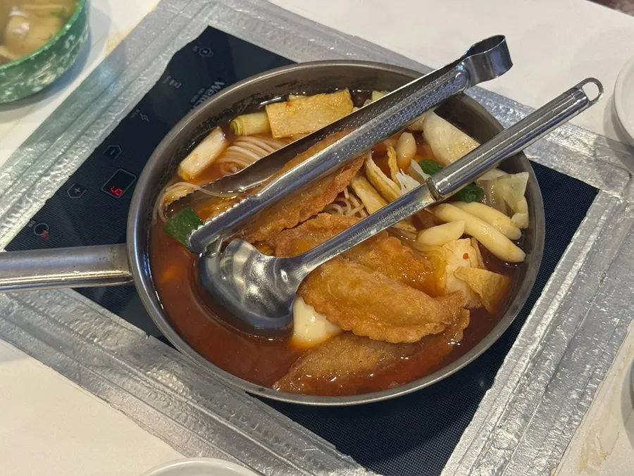 Pot of instant tteokbokki with rice cake, fish cake, jjolmyeon noodles, and fried mandu