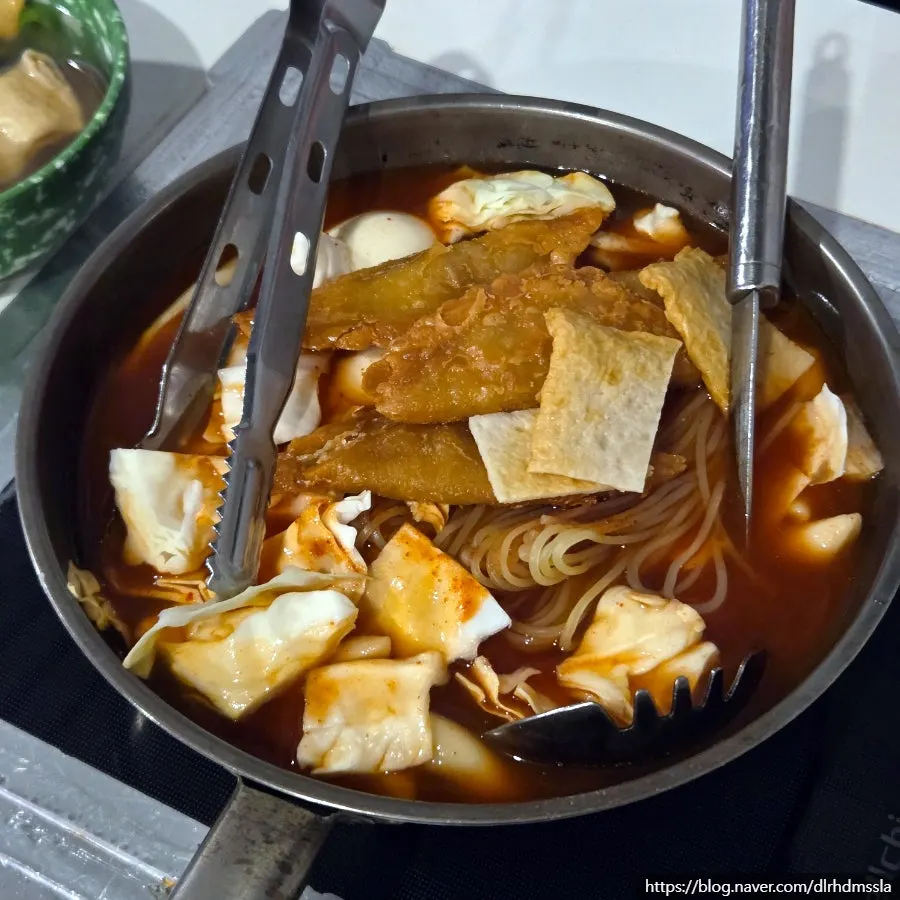 Close-up of skewered fish cake served with broth