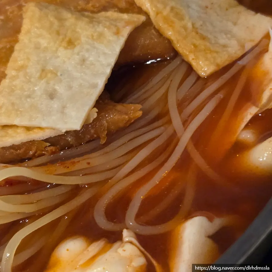 Instant tteokbokki topped with cabbage and fried dumplings