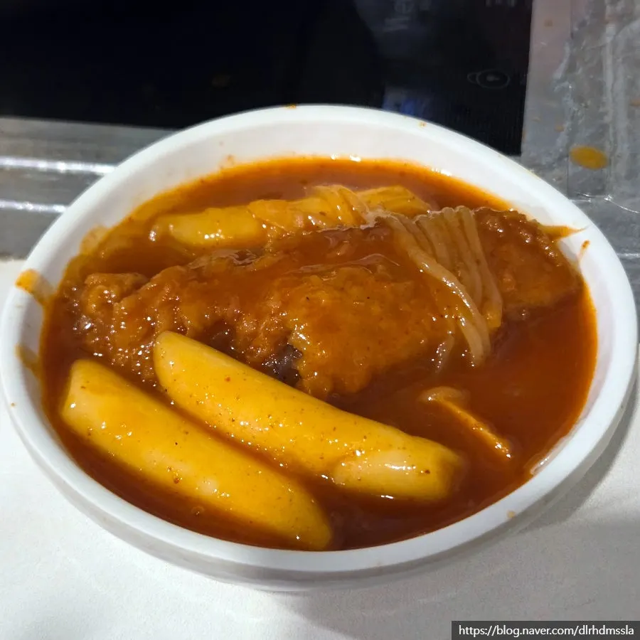 Close-up of tteokbokki soaked in spicy sauce