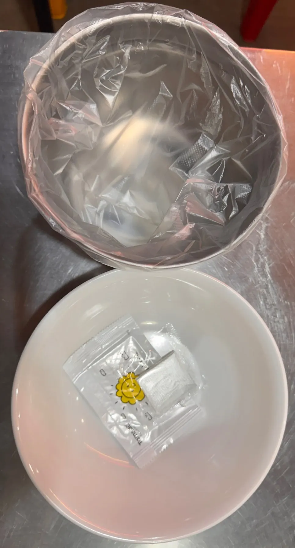 Individually wrapped wet wipe and bone bucket on the small plate
