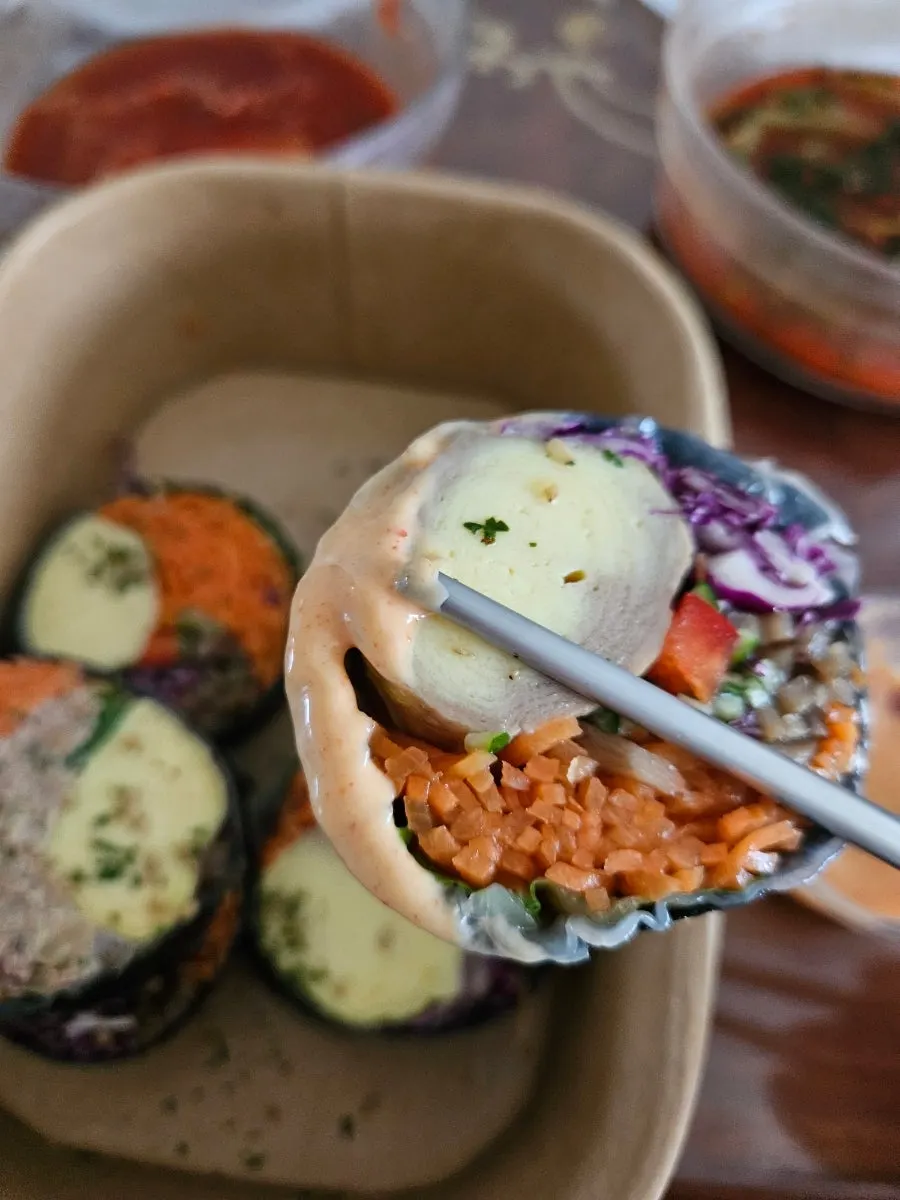 Keto gimbap being dipped into sauce