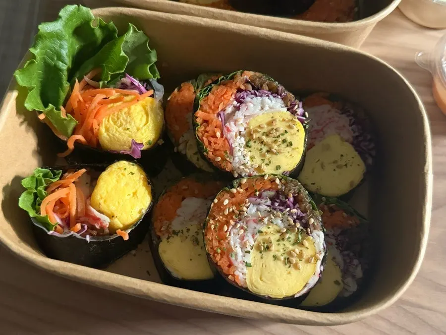 Two rolls of keto gimbap in a takeout container