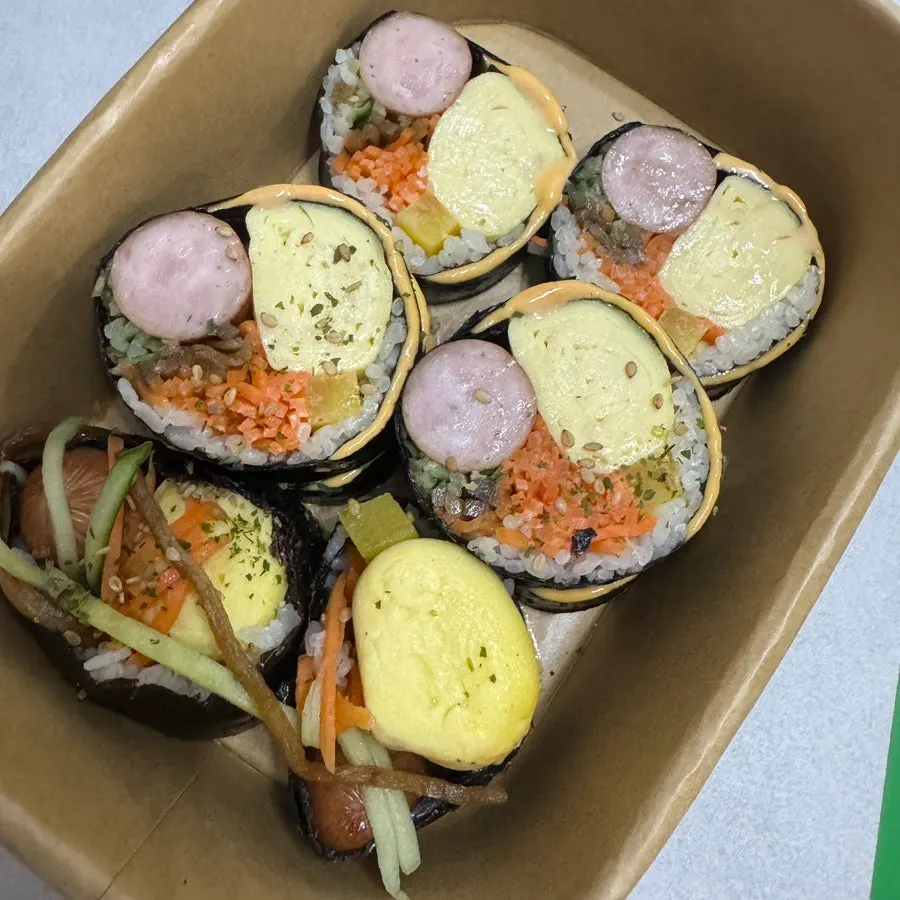 Cross-section of whole sausage cheese gimbap showing thick sausage