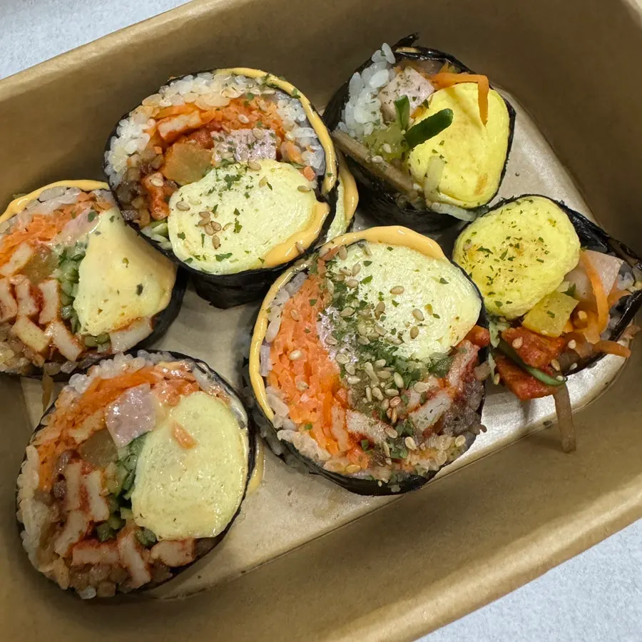 Cross-section of cheese vegetable whole egg gimbap with large egg portion