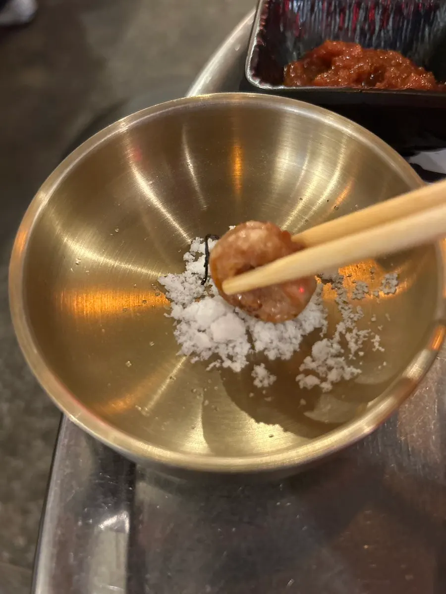 A wrap made with jeotgal rice, ssamjang, and mushrooms