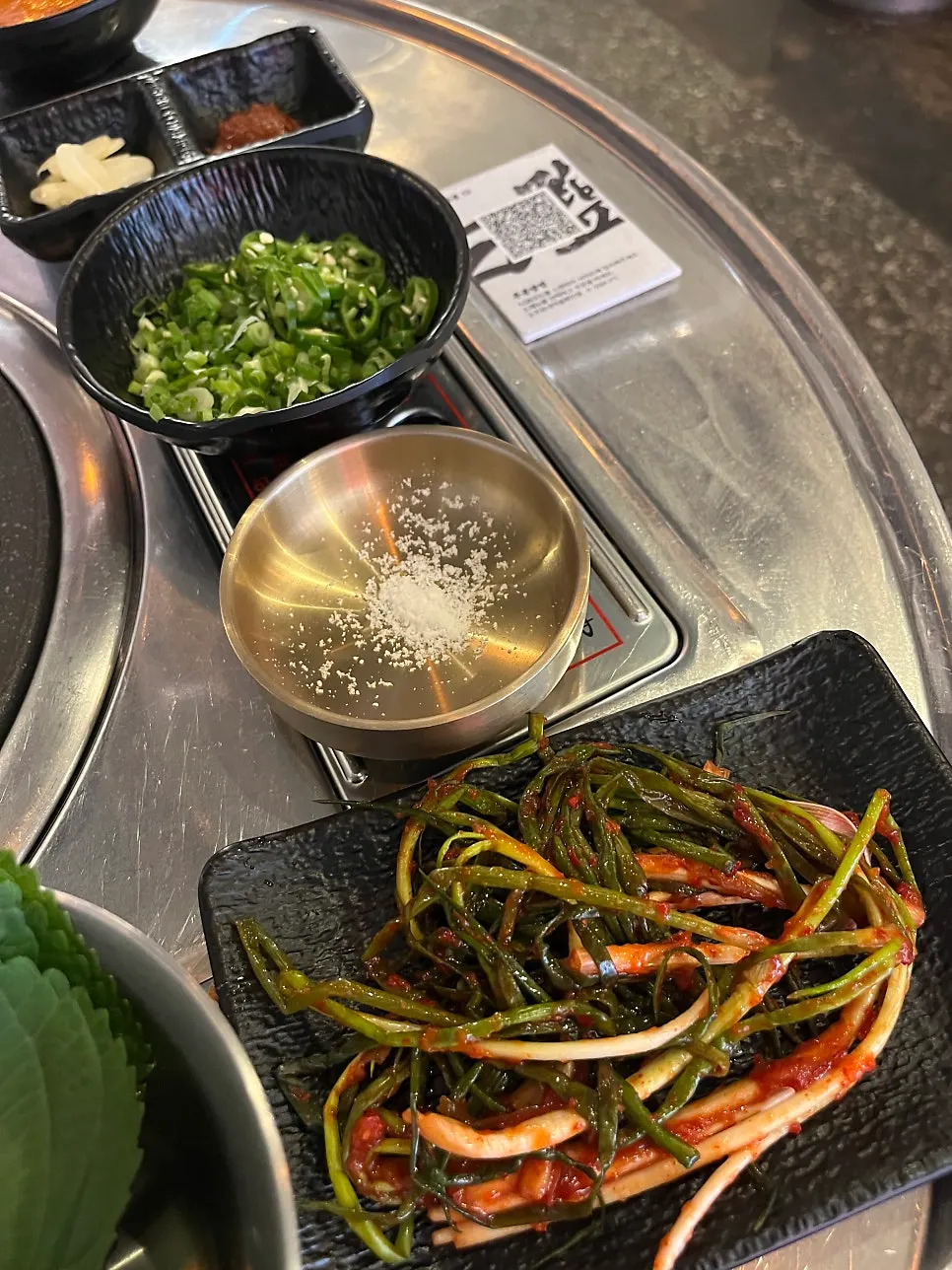 Two servings of Daegu makchang and side orders set on the table