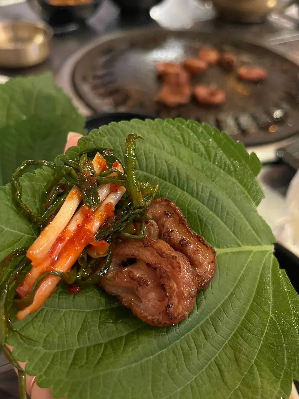 Makchang and scallion salad wrapped in a perilla leaf