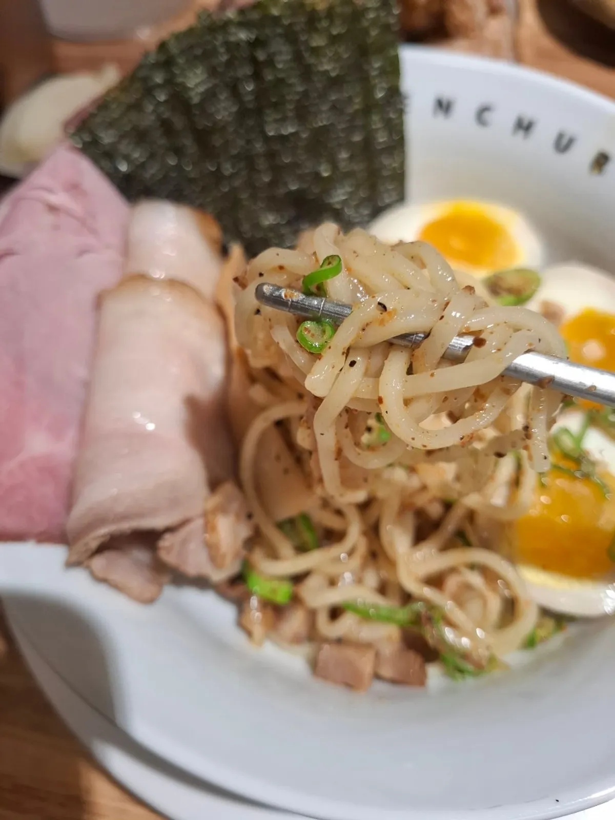 Lifting a bite of tsukemen noodles