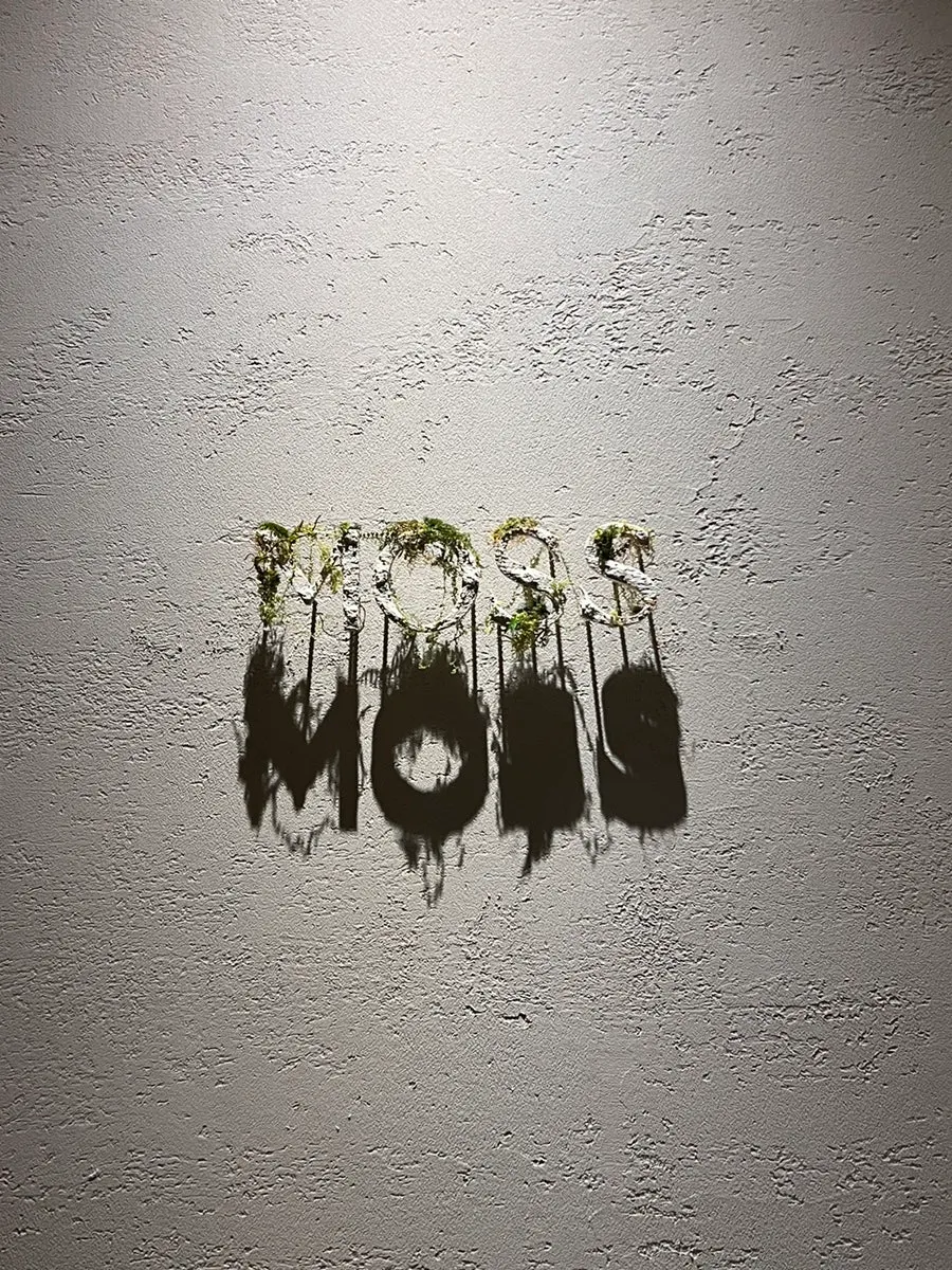 Moss sign and second-floor directions in an alley near Euljiro 3-ga Station