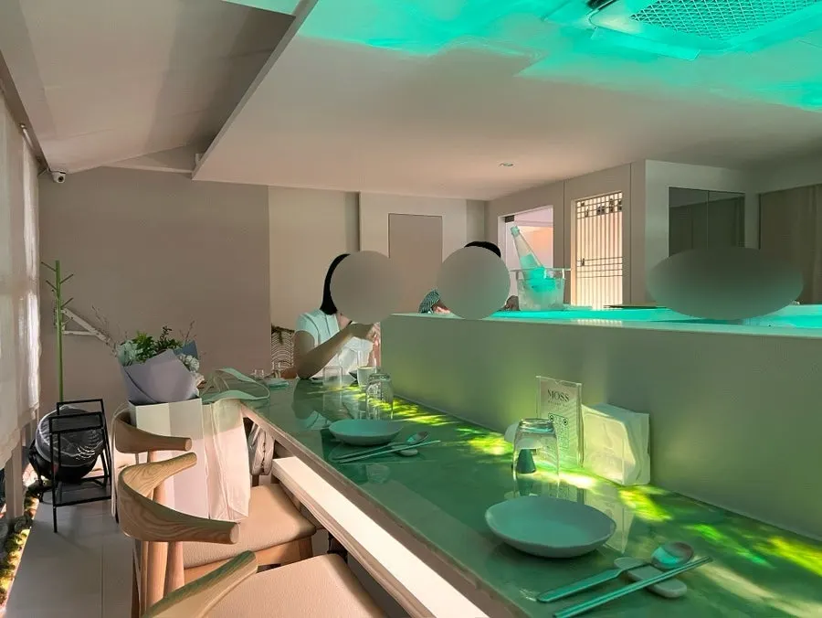 Moss seating under soft green lighting