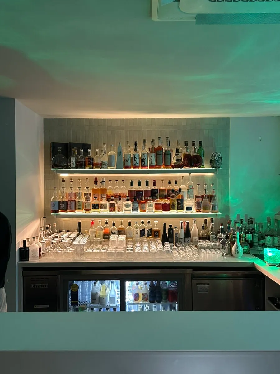 Shelf of traditional liquors and whiskies at Moss