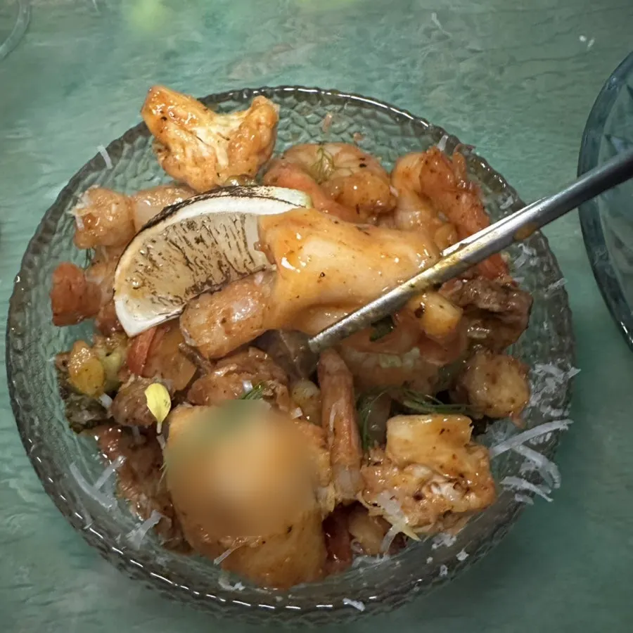 A plate of seafood stir-fry served with vegetables