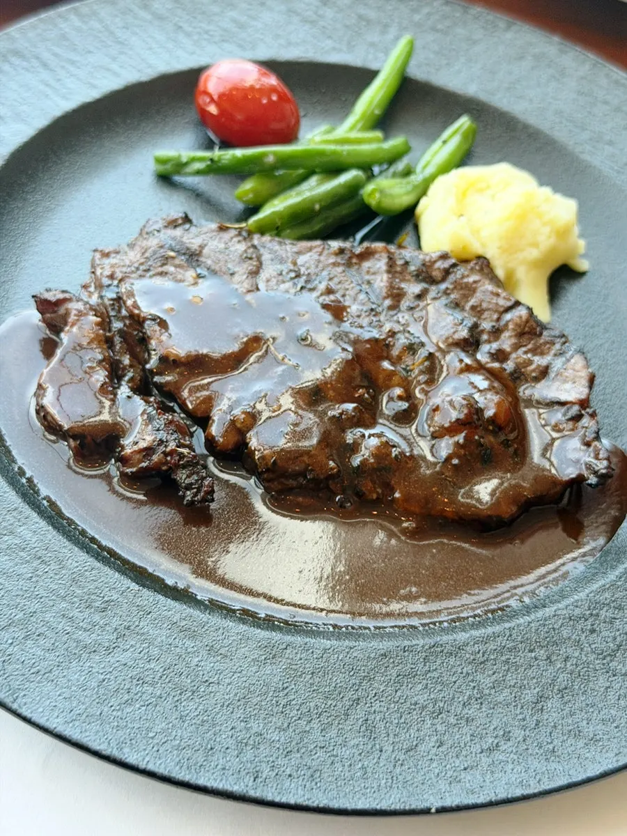 Flat iron steak served with the Asian buffet