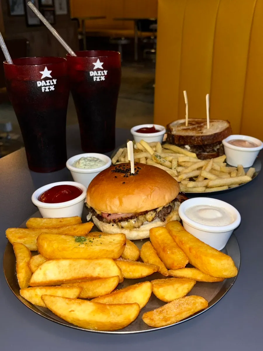 Table setup with bacon cheeseburger and patty melt