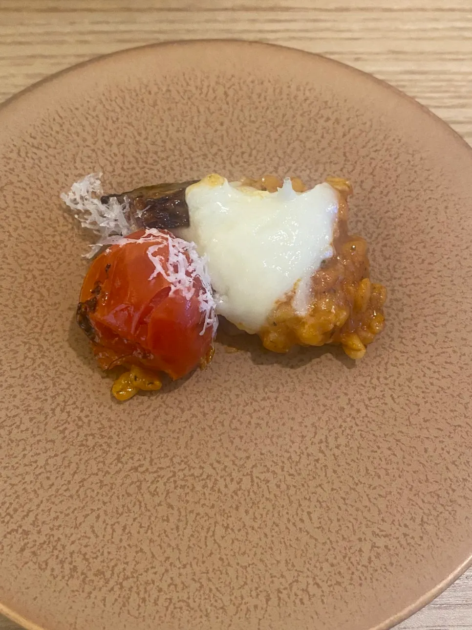 Risotto mixed with tomato and cheese