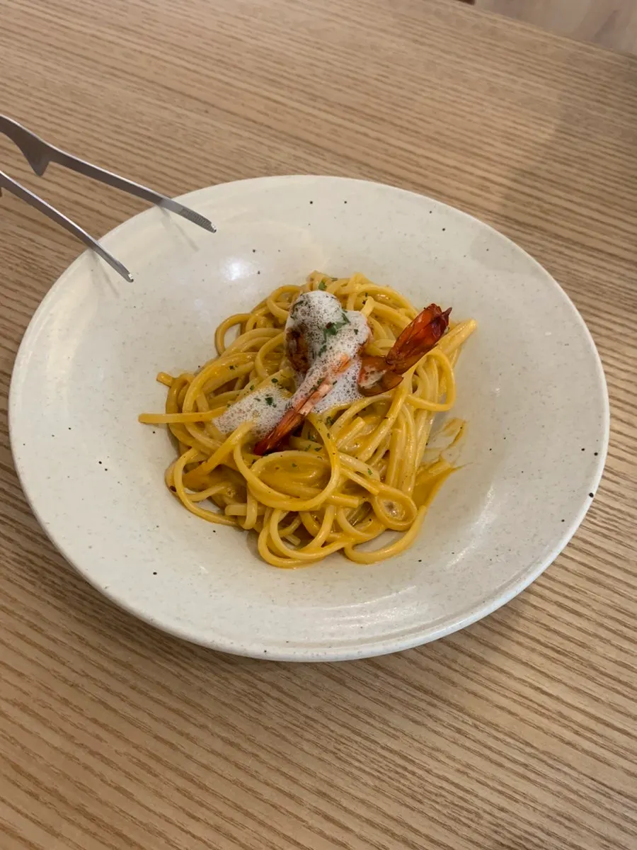 Photo of bisque pasta topped with shrimp
