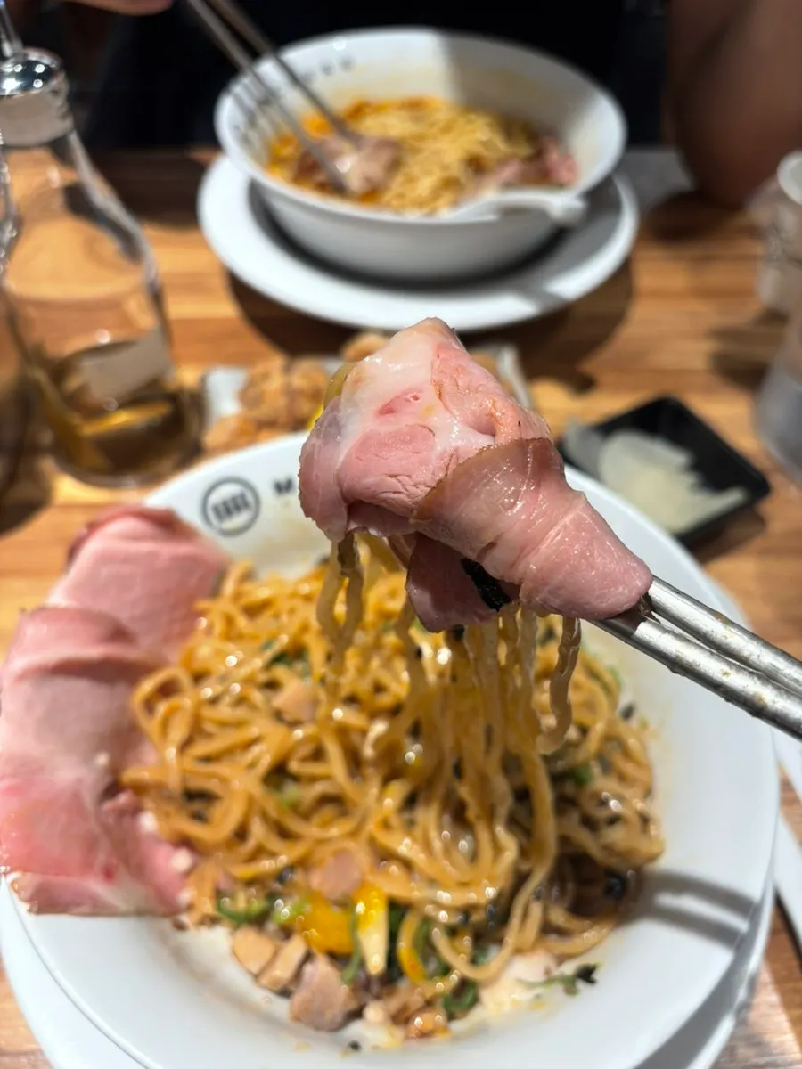 A chopstick-full of abura soba mixed with minced meat