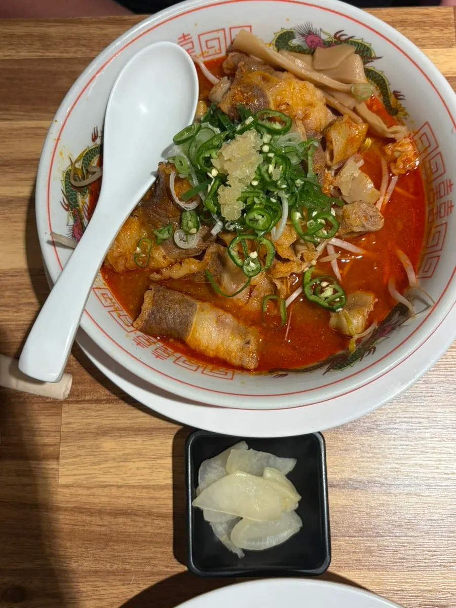 Table set with the ordered motsu ramen, shoyu ramen, and handmade karaage