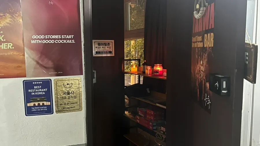 Stairs leading up to the store with restroom signage