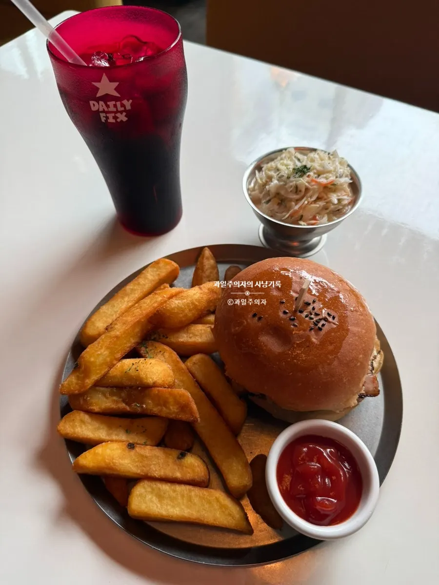 Three-shot of the burger, fries, and coleslaw