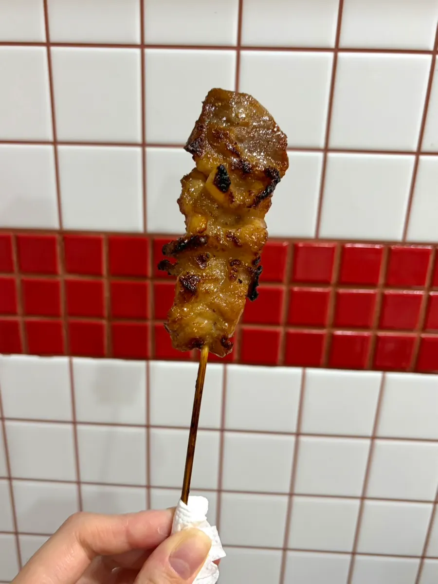 Close-up of a glistening moo ping skewer