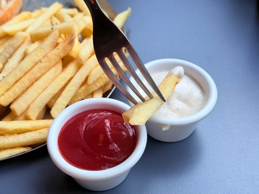 Fries dipped in ranch sauce