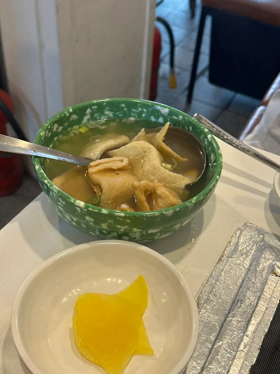 Sweet potato fritter dipped in tteokbokki broth