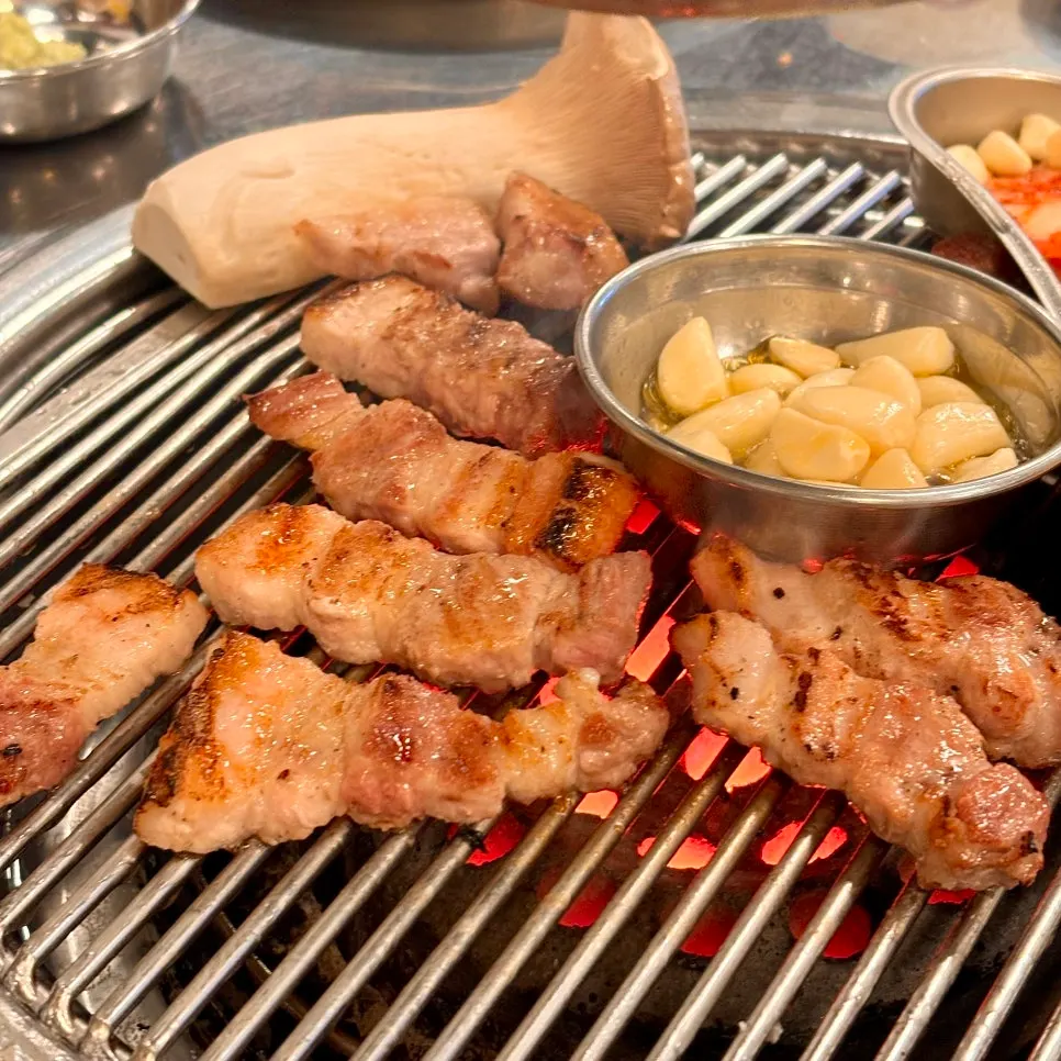 Mushrooms and pork belly on the charcoal grill