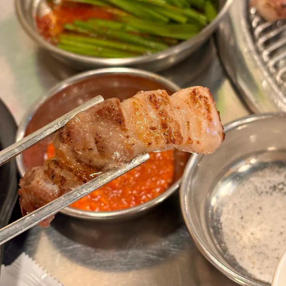 Fully cooked charcoal-grilled pork belly with visible juices