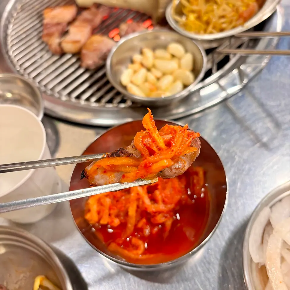 A piece of pork belly paired with side dishes