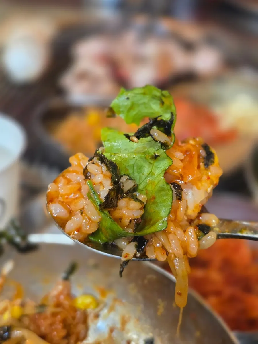 Bibimbap mixed together in the metal bowl