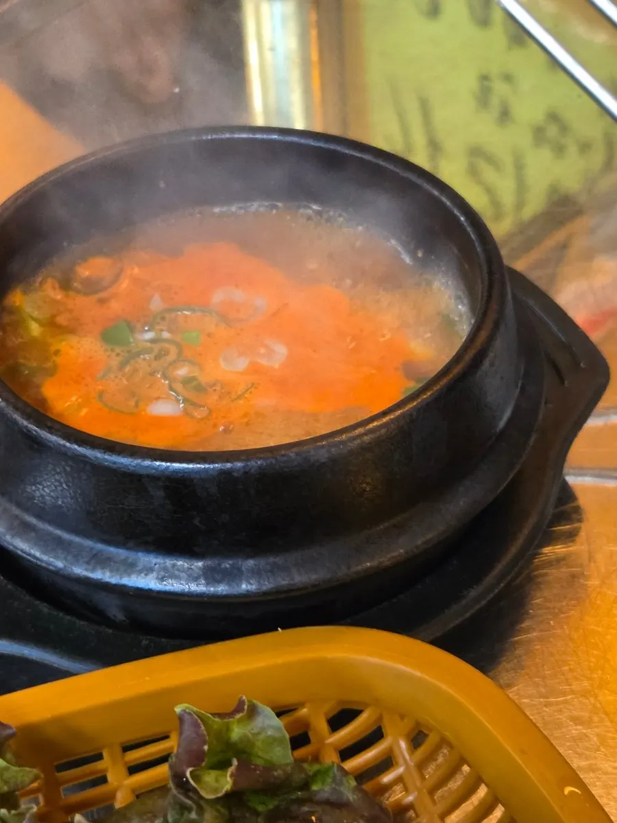 Bibimbap topped with a piece of grilled meat