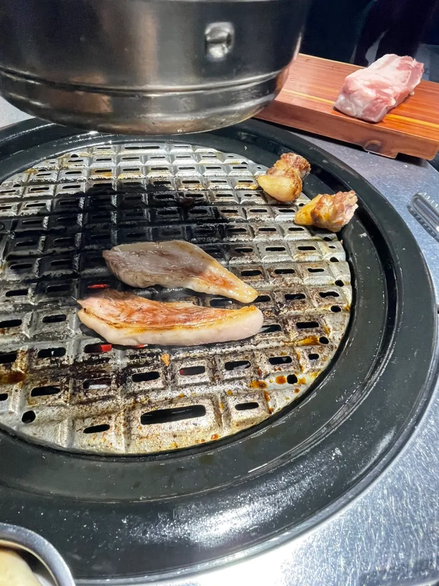 Grilled meat served onto a plate