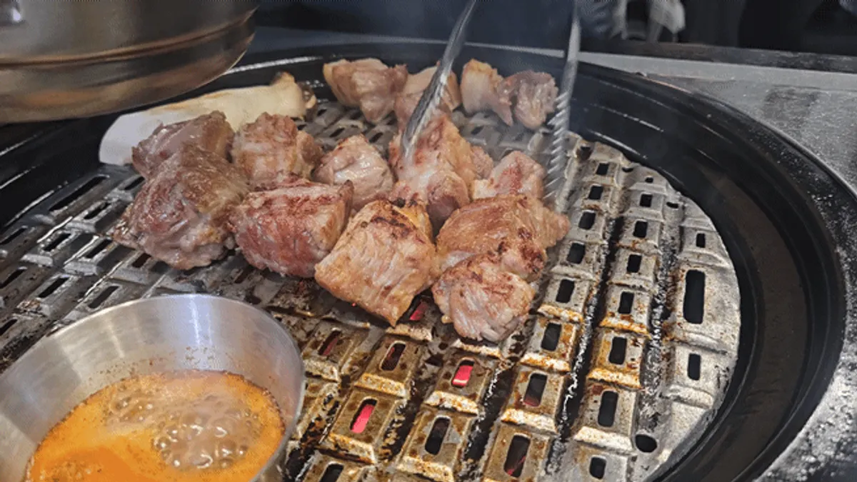 Staff grilling meat on the grill